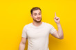 © luismolinero - Handsome man over yellow background pointing with the index finger a great idea