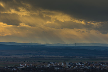 Wall Mural - landschaft und haeuser und windraeder mit sonnenstrahlen