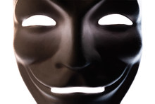 Dark Mask Isolated On White. Close-up. Smile Symbol Of An Anonymous Hacker. Shooting A Subject In A Dark Key.