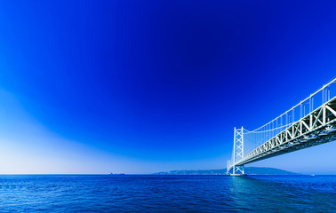 Wall Mural - Landscape of Akashi Kaikyo Bridge in the background of blue sky in the summer morning