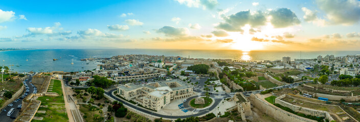 Aerial summer sunset view of Acco, Acre, Akko medieval old city with green roof Al Jazzar mosque and crusader palace, city walls, arab market,  knights hall, crusader tunnels,  in Israel