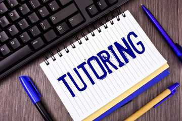 Poster - Word writing text Tutoring. Business concept for Mentoring Teaching Instructing Preparing Supporting Give lessons written Notepad wooden grey background Pens and Black Keyboard next to it.