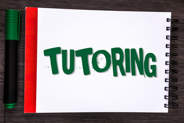 Poster - Writing note showing Tutoring. Business photo showcasing Mentoring Teaching Instructing Preparing Supporting Give lessons written Notepad the wooden Grey background Marker next to it.