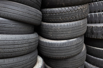 old used car tires stacked in piles