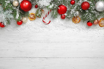 christmas decoration with snow on white wooden background, flat lay. space for text