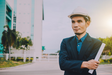 Engineer holding paper factory plant background