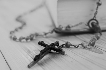 Wall Mural - Closeup Catholic rosary beads with crucifix on wooden background.