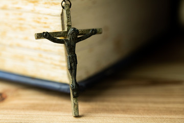 Wall Mural - Closeup Catholic rosary beads with crucifix on wooden background.