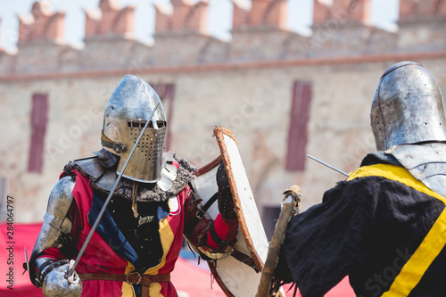 Fotomural Two knights during a duel on the background of the wall of the ancient castle_