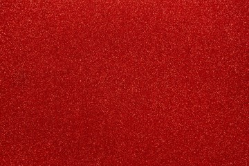 Red glitters abstract shiny background. Scarlet design paper texture for decoration and design of Christmas, New Year or other holiday pictures. Beautiful packaging material.