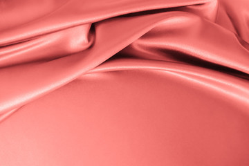 Wall Mural -  Smooth elegant wavy coral pink satin silk luxury cloth fabric texture, abstract background design.
