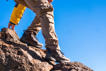 close up of hiker equipment with man going down from the mountain - sport outdoor leisure activity f