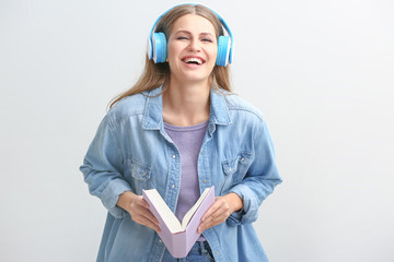 Sticker - Young woman listening to audiobook on white background