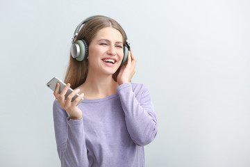 Sticker - Young woman listening to audiobook on white background