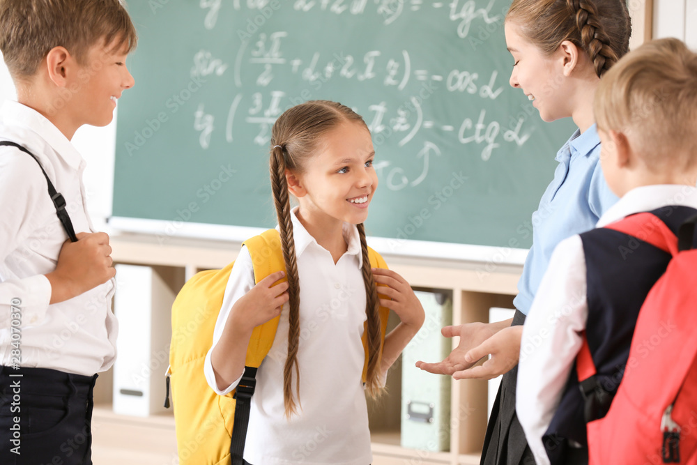 Cute little pupils in classroom