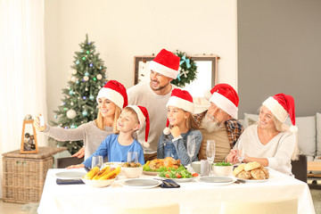 Happy family taking selfie during Christmas dinner at home