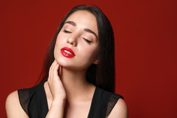 Canvas Print - Beautiful young woman with bright lipstick on color background