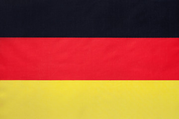 German national fabric flag, textile background. Symbol of international world european country.