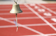 bell to signal the last lap to the athletes