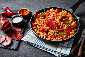 Wall Mural - fried Chickpeas with chorizo and spices, close-up