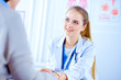 © khmelev - Female doctor holds the patient's hand in the office
