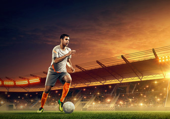 Wall Mural - Professional soccer player in action on a soccer stadium. Soccer championship. Dramatic night sky