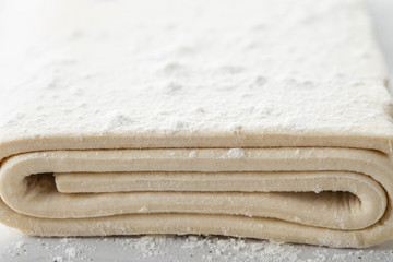 Wall Mural - Fresh raw dough on table. Puff pastry. Copy space.