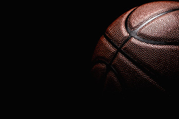 Wall Mural - basketball ball on black background.