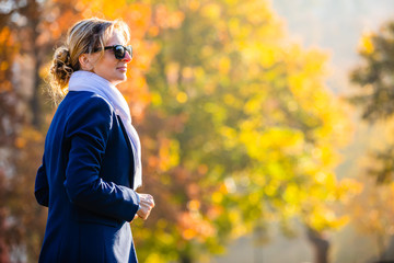 Wall Mural - middle-aged woman walking in city park