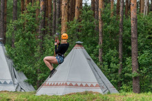 Girl Pulls Out On A Bungee Against The Background Of The Forest
