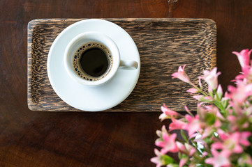 A cup of faeces musk espresso coffee on wooden table