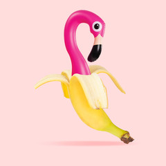 An alternative view of usual fruits. Banana as a pink flamingo on coral background. Negative space to insert your text. Modern design. Contemporary art collage. Concept of nutrition, emotions, taste.