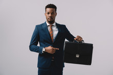 African American Man Pointing With Finger At Briefcase Isolated On Grey