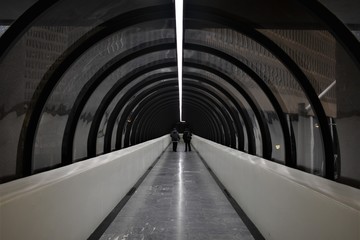 Long pedestrian bridge connecting two buildings