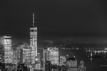 Fototapete - New York City skyline with lower Manhattan skyscrapers in storm at night. Black and white image.