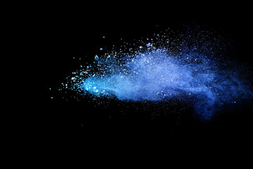 Blue powder explosion on black background. Colored cloud. Colorful dust explode. Paint Holi.