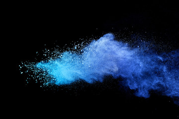 Wall Mural - blue powder explosion on black background. colored cloud. colorful dust explode. paint holi.