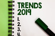 Conceptual hand writing showing Trends 2019. Business photo showcasing Upcoming year prevailing tendency Widely Discussed Online Marker over notebook white page communicating ideas messages