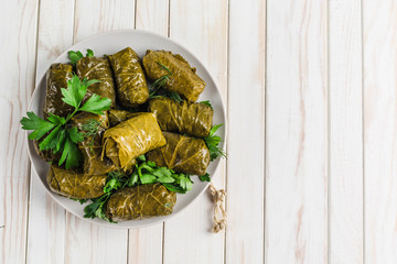 delicious stuffed grape leaves (traditional doom mediterranean cuisine dolma) on a black plate with 