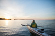 © Rob and Julia Campbell/Stocksy - Two people kayaking in the sunshine.