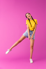 Canvas Print - Full length photo of young joyful woman wearing denim shorts having fun and dancing