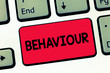 © Artur - Text sign showing Behaviour. Conceptual photo way in which one acts conducts oneself especially towards others Keyboard key Intention to create computer message, pressing keypad idea