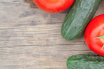 tomatoes and cucumbers on wooden background