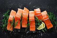 Salmon. Fresh Raw Salmon Fish Fillet With Cooking Ingredients, Herbs And Lemon On Black Background, Top View