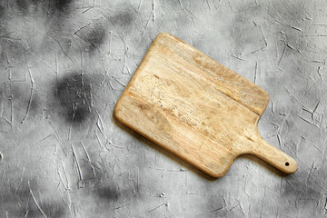 Wall Mural - Empty cutting board from pine wood on  stone table, grey background, top view