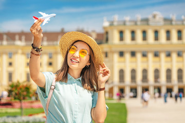 Wall Mural - Happy young asian woman travel in Schoenbrunn royal palace garden. Travel and tourism in Vienna and Austria. Air flights and airplane transport
