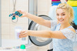 © anetlanda - Happy woman showing laundry pods capsules and powder
