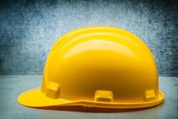 Wall Mural - yellow  construction helmet on metalic background close up side view