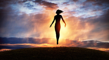 silhouette of woman rising into heaven. levitation. have a positive mindset.