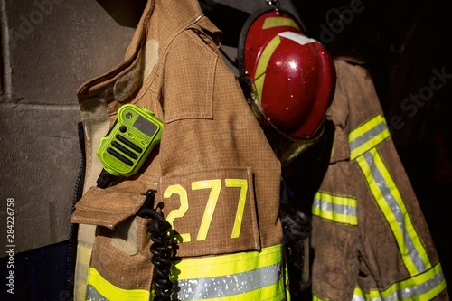 Obraz na plátně Firefighter protection gear hanging on fire station wall